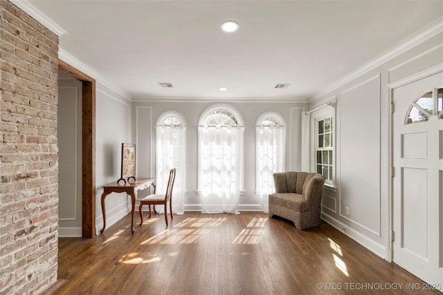 1510 S College Ave, Tulsa, OK 74104 - sitting room featuring plenty of natural light, a decorative wall, ornamental molding, and dark wood-type flooring