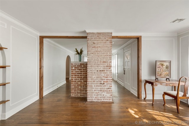 1510 S College Ave, Tulsa, OK 74104 - living room featuring ornamental molding, dark wood-type flooring, arched walkways, and a decorative wall