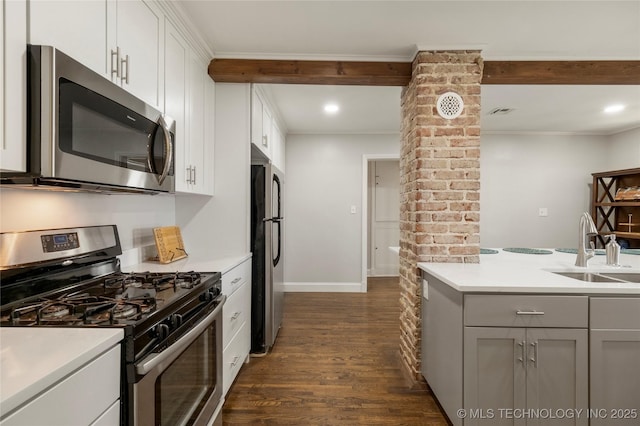 1510 S College Ave, Tulsa, OK 74104 - kitchen featuring appliances with stainless steel finishes, dark wood-style floors, light countertops, gray cabinets, and ornamental molding