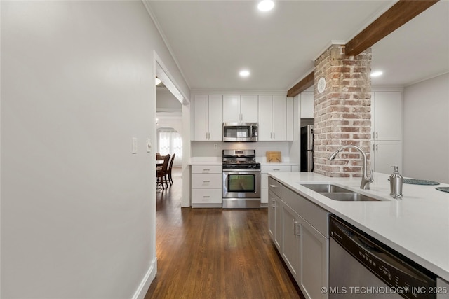 1510 S College Ave, Tulsa, OK 74104 - kitchen with appliances with stainless steel finishes, ornamental molding, light countertops, white cabinetry, and dark wood-type flooring