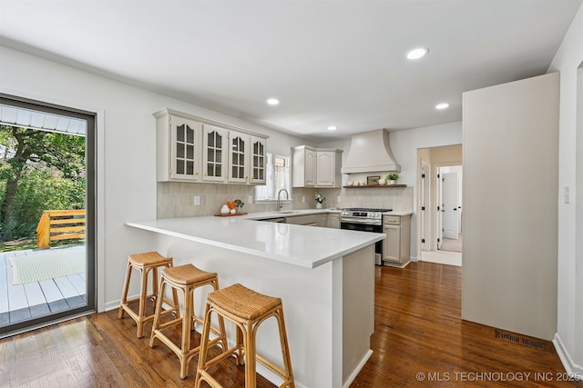 10 E 31st Pl, Sand Springs, OK 74063 - kitchen featuring stainless steel range with gas stovetop, premium range hood, a peninsula, open shelves, and a breakfast bar