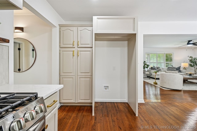 10 E 31st Pl, Sand Springs, OK 74063 - kitchen featuring dark wood finished floors, light stone countertops, ceiling fan, and open floor plan