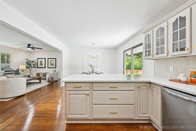 10 E 31st Pl, Sand Springs, OK 74063 - kitchen featuring dishwasher, a peninsula, glass insert cabinets, and plenty of natural light