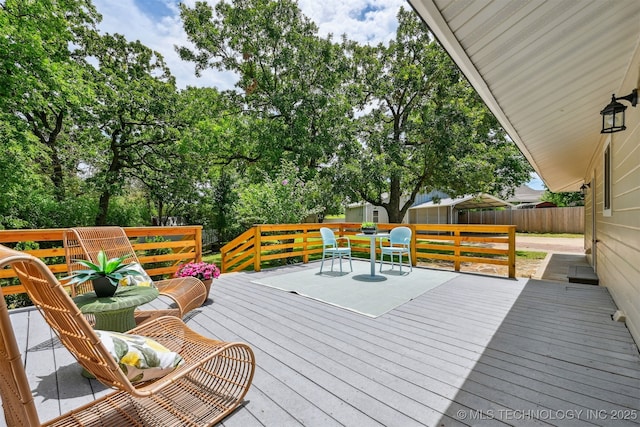 10 E 31st Pl, Sand Springs, OK 74063 - wooden deck featuring a fenced backyard, an outbuilding, and view of scattered trees