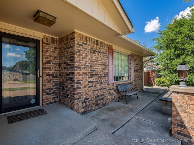 317 NE Autumn Ct, Bartlesville, OK 74006 - property entrance with brick siding and a patio