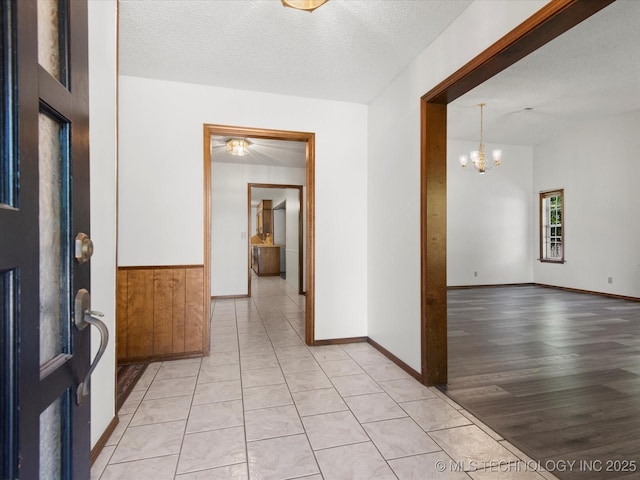 317 NE Autumn Ct, Bartlesville, OK 74006 - foyer featuring a chandelier, a textured ceiling, and light wood-style flooring