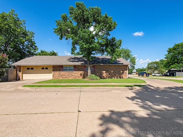 317 NE Autumn Ct, Bartlesville, OK 74006 - view of front of home with driveway, a garage, and brick siding