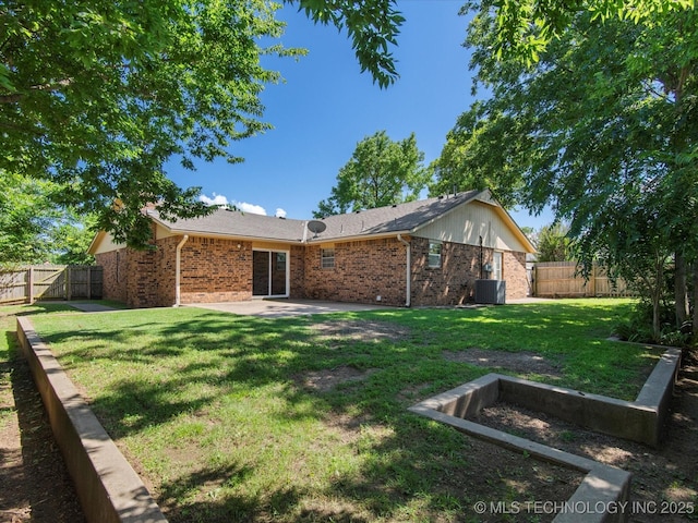 317 NE Autumn Ct, Bartlesville, OK 74006 - back of house with brick siding, a patio, and a fenced backyard