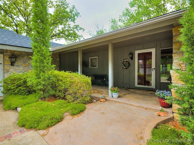 1201 Dogwood Ct, Bartlesville, OK 74006 - property entrance with board and batten siding and stone siding