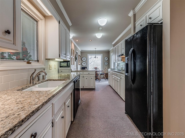 1201 Dogwood Ct, Bartlesville, OK 74006 - kitchen with black appliances, ornamental molding, tasteful backsplash, hanging light fixtures, and carpet