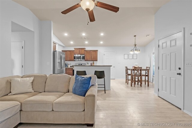 8745 S 261st E Ave, Broken Arrow, OK 74014 - living room featuring vaulted ceiling, a ceiling fan, light wood-style flooring, a chandelier, and recessed lighting
