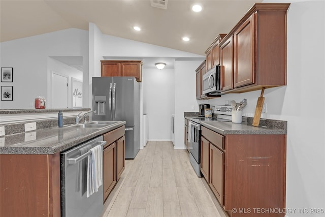 8745 S 261st E Ave, Broken Arrow, OK 74014 - kitchen featuring appliances with stainless steel finishes, lofted ceiling, light wood-style flooring, recessed lighting, and brown cabinetry