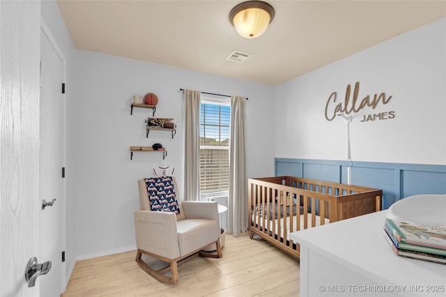 8745 S 261st E Ave, Broken Arrow, OK 74014 - bedroom with light wood finished floors and a crib