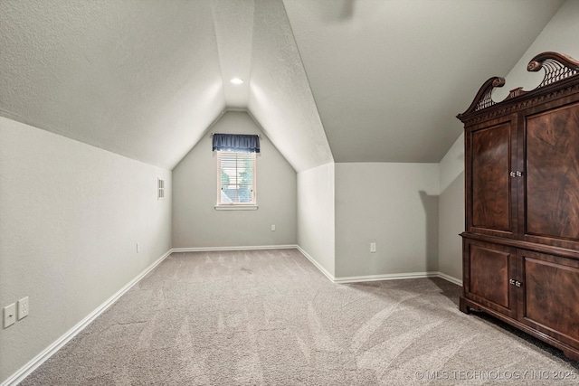 11248 S 75th Ave E, Bixby, OK 74008 - additional living space with lofted ceiling, light colored carpet, and a textured ceiling
