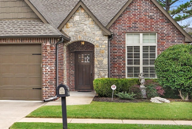 11248 S 75th Ave E, Bixby, OK 74008 - view of front of home with roof with shingles, brick siding, a garage, and stone siding