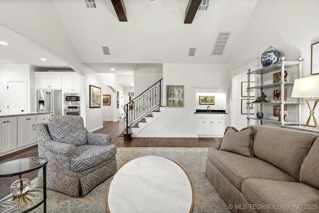 11248 S 75th Ave E, Bixby, OK 74008 - living room with high vaulted ceiling, dark wood-type flooring, arched walkways, stairs, and beamed ceiling