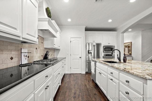 11248 S 75th Ave E, Bixby, OK 74008 - kitchen with stainless steel appliances, recessed lighting, white cabinets, light stone countertops, and ornamental molding