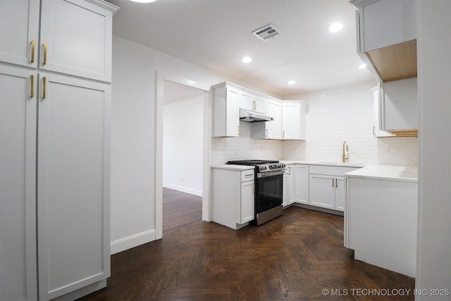 209 E Falletti Ave, Claremore, OK 74017 - kitchen with gas stove, under cabinet range hood, decorative backsplash, light countertops, and recessed lighting