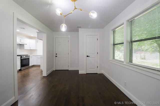 209 E Falletti Ave, Claremore, OK 74017 - unfurnished dining area featuring dark wood-type flooring and a chandelier