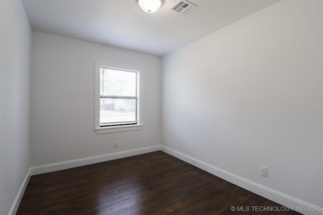 209 E Falletti Ave, Claremore, OK 74017 - spare room featuring dark wood finished floors and baseboards