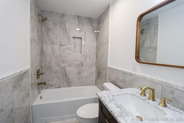 209 E Falletti Ave, Claremore, OK 74017 - bathroom featuring tile walls, vanity, tub / shower combination, and a wainscoted wall