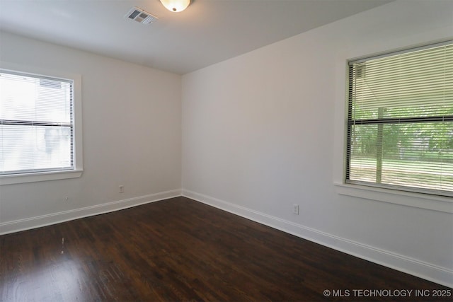 209 E Falletti Ave, Claremore, OK 74017 - spare room featuring dark wood-style flooring and baseboards