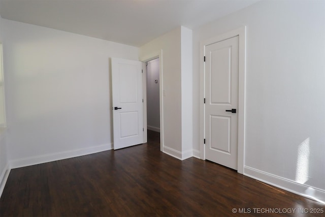 209 E Falletti Ave, Claremore, OK 74017 - spare room featuring dark wood finished floors and baseboards