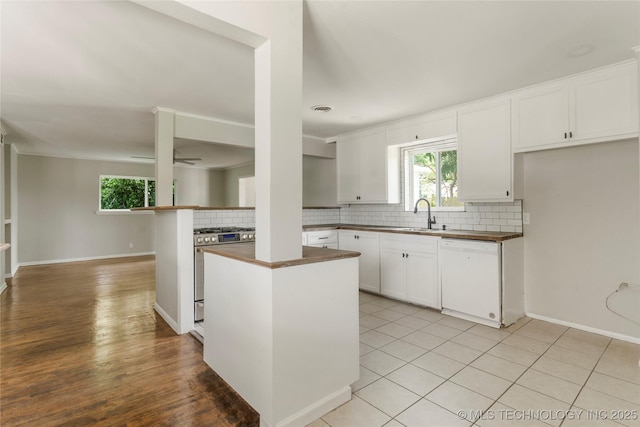 2904 S Hudson Pl, Tulsa, OK 74114 - kitchen featuring stainless steel gas range oven, dishwasher, dark countertops, tasteful backsplash, and healthy amount of natural light