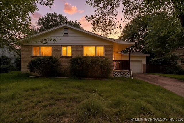 2904 S Hudson Pl, Tulsa, OK 74114 - view of front of property with driveway, brick siding, a garage, and a front lawn