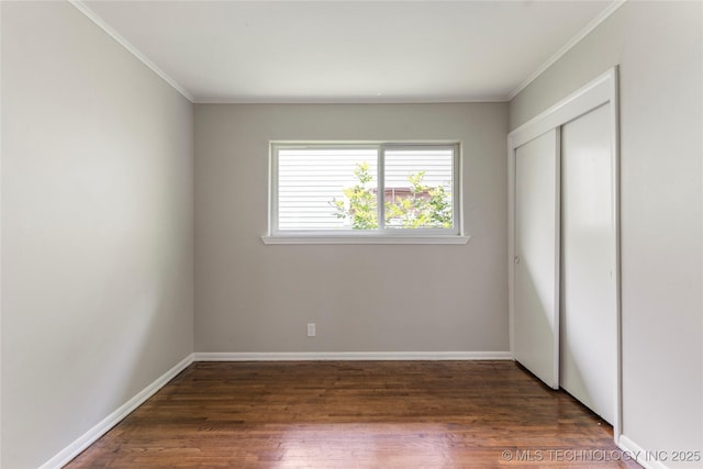 2904 S Hudson Pl, Tulsa, OK 74114 - unfurnished bedroom with wood finished floors, crown molding, and a closet