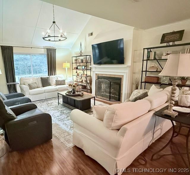 31990 S 624th Pl Unit 65, Grove, OK 74344 - living room featuring wood finished floors, a chandelier, a tiled fireplace, and lofted ceiling
