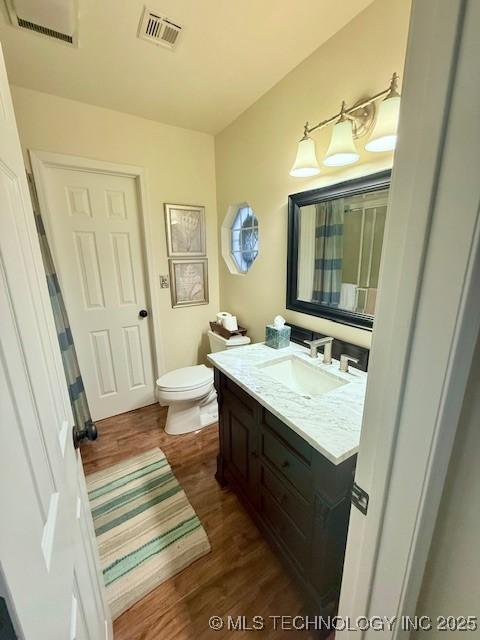31990 S 624th Pl Unit 65, Grove, OK 74344 - full bathroom featuring vanity, wood finished floors, and curtained shower