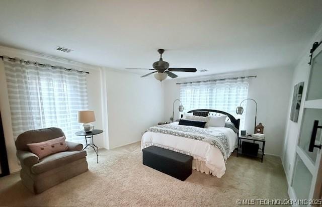 31990 S 624th Pl Unit 65, Grove, OK 74344 - bedroom featuring carpet flooring, a barn door, and ceiling fan