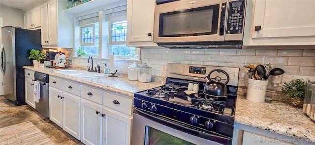 108256 Pike St, Checotah, OK 74426 - kitchen with stainless steel appliances, white cabinets, decorative backsplash, and light stone countertops