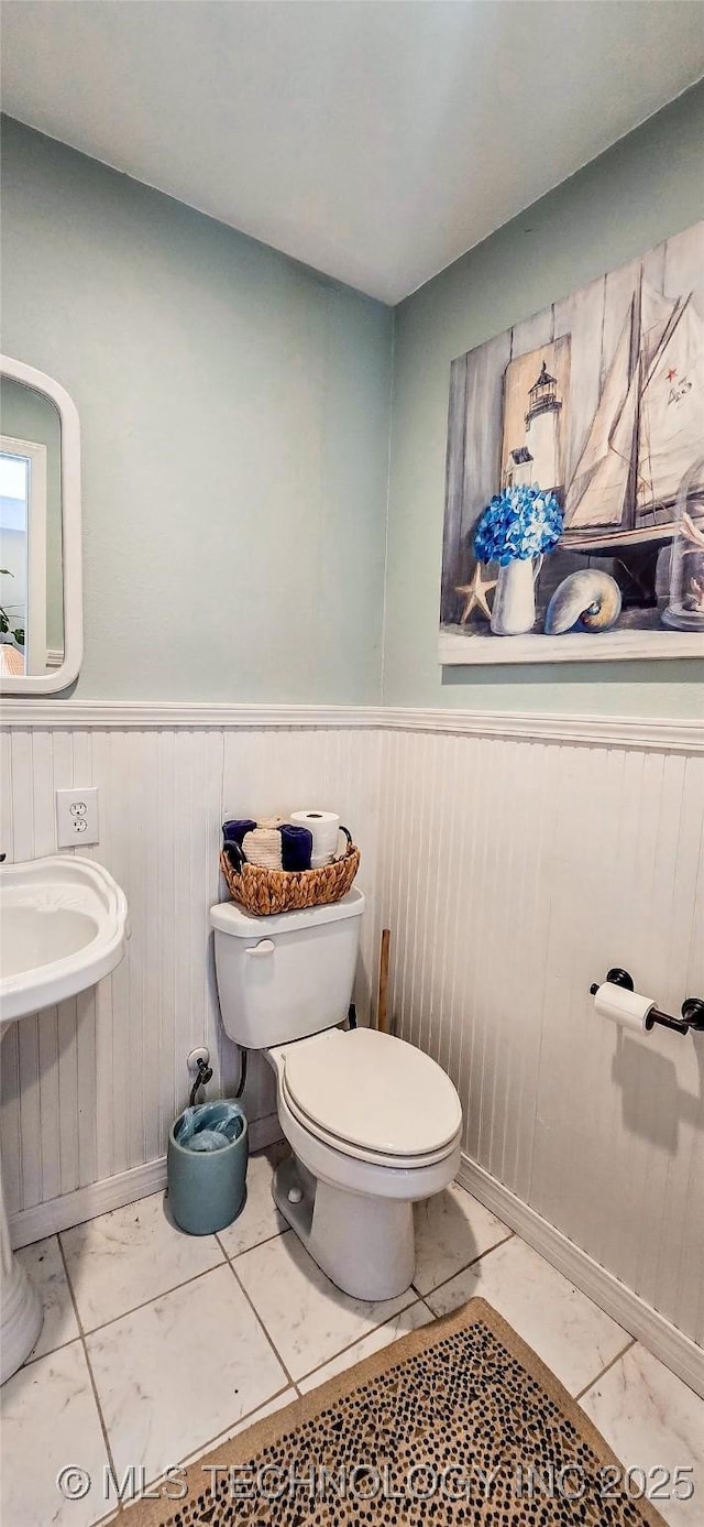 108256 Pike St, Checotah, OK 74426 - half bathroom featuring wainscoting and wooden walls