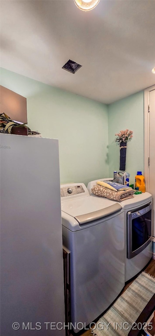 108256 Pike St, Checotah, OK 74426 - laundry area with washer and dryer and wood finished floors