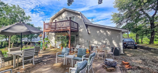 108256 Pike St, Checotah, OK 74426 - back of house featuring outdoor dining area, a balcony, a gambrel roof, and a patio area