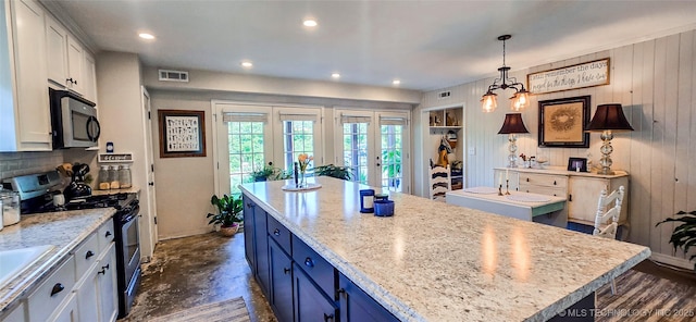 108256 Pike St, Checotah, OK 74426 - kitchen featuring appliances with stainless steel finishes, a center island, white cabinets, blue cabinets, and french doors