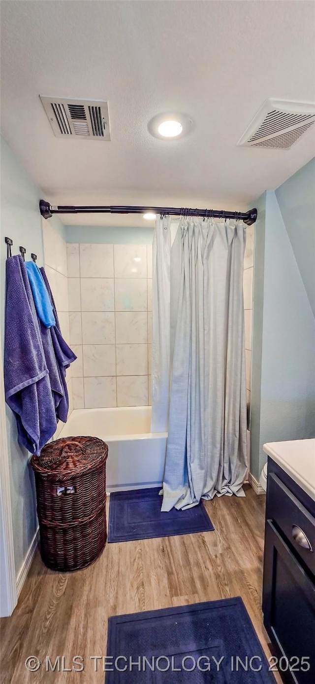 108256 Pike St, Checotah, OK 74426 - bathroom with wood finished floors, shower / bath combo with shower curtain, and vanity