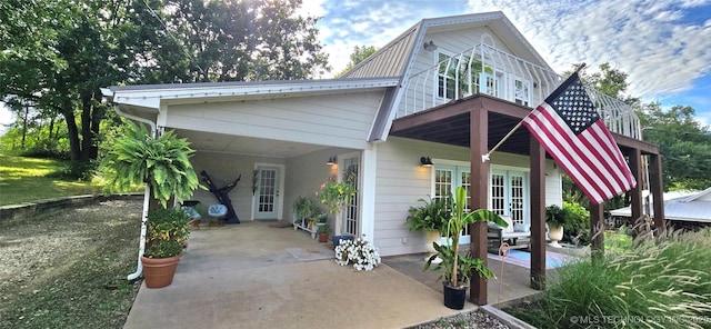 108256 Pike St, Checotah, OK 74426 - view of front of home with a gambrel roof, french doors, and a metal roof