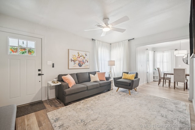 2837 E Admiral Ct, Tulsa, OK 74110 - living room with healthy amount of natural light, wood finished floors, and a ceiling fan