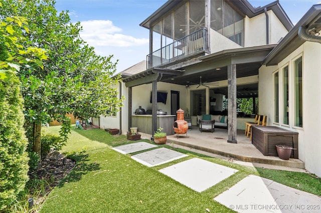 4603 E 118th Pl, Tulsa, OK 74137 - rear view of house with ceiling fan, a patio, a balcony, a yard, and stucco siding