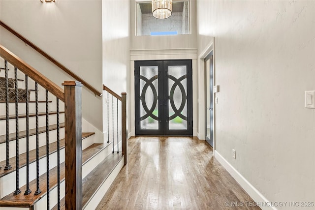 4603 E 118th Pl, Tulsa, OK 74137 - entryway featuring a high ceiling, wood finished floors, stairway, and french doors