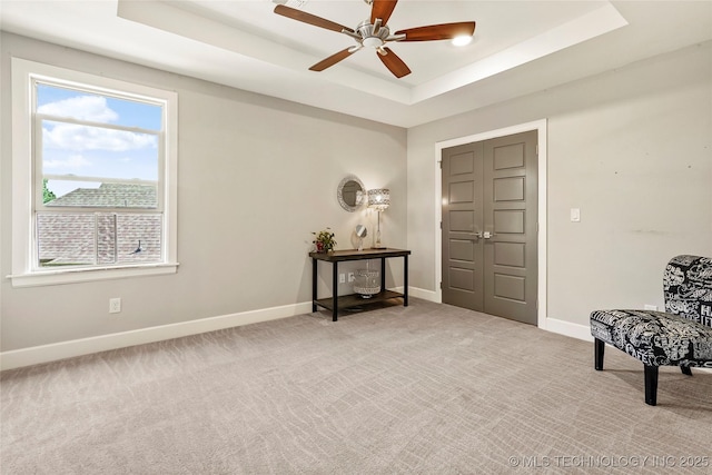4603 E 118th Pl, Tulsa, OK 74137 - sitting room with a tray ceiling, ceiling fan, and light colored carpet