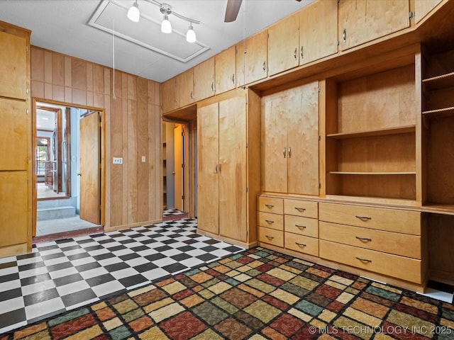 927 Macklyn Ln, Bartlesville, OK 74006 - unfurnished bedroom with attic access, tile patterned floors, and wooden walls