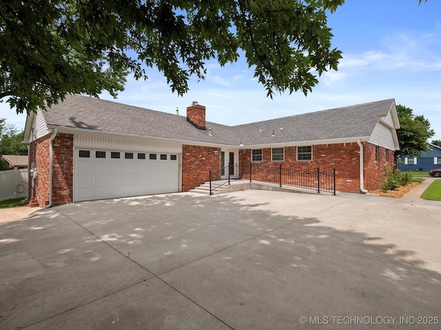927 Macklyn Ln, Bartlesville, OK 74006 - ranch-style home with brick siding, driveway, a chimney, and an attached garage