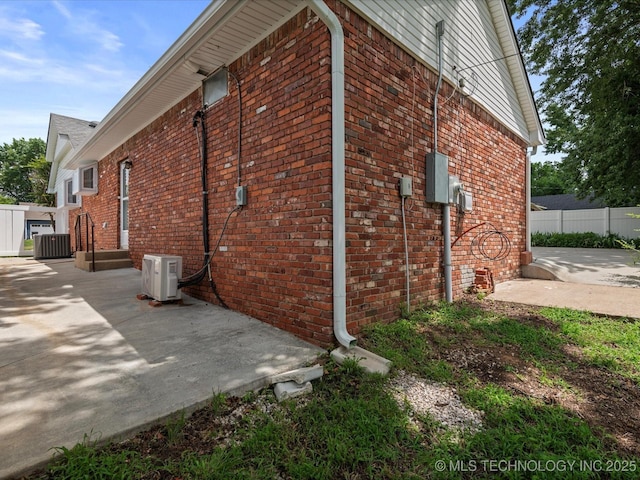 927 Macklyn Ln, Bartlesville, OK 74006 - view of side of property with brick siding and a patio area