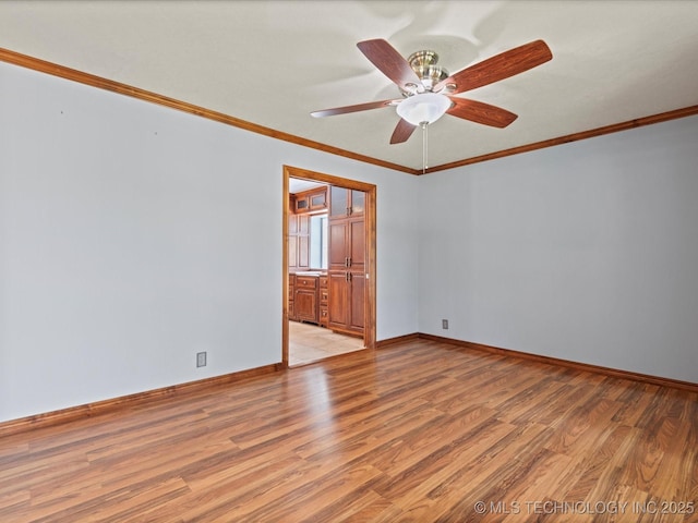 927 Macklyn Ln, Bartlesville, OK 74006 - unfurnished room with light wood-style floors, ornamental molding, and a ceiling fan