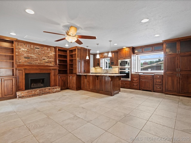 927 Macklyn Ln, Bartlesville, OK 74006 - kitchen featuring appliances with stainless steel finishes, a peninsula, recessed lighting, light tile patterned floors, and a breakfast bar area
