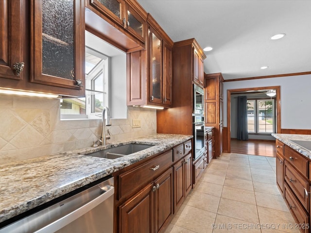 927 Macklyn Ln, Bartlesville, OK 74006 - kitchen featuring appliances with stainless steel finishes, light stone counters, light tile patterned floors, recessed lighting, and crown molding